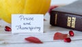 Praise and thanksgiving handwritten text message with closed Holy Bible Book, and fresh fall fruits