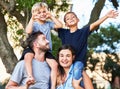 Praise your children openly, reprehend them secretly. Portrait of a beautiful family with their sons on their shoulders Royalty Free Stock Photo