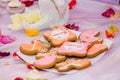 Pram shaped gingerbread cookies on white plate. Candy bar with sweets for girl birthday party. Royalty Free Stock Photo