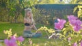 Pranayama yoga breath exercise by a young woman in the backyard of her house. Royalty Free Stock Photo