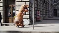 Prankster in dinosaur costume in crowd of people walking on city sidewalk