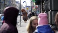 Prankster in mascot costume prankster running on city pavement