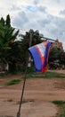 Prapor cambodia swaying in the wind, an overcast evening in south east asia