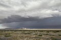 Prarie landscape beneats a dark bluegrey clouded sky Royalty Free Stock Photo