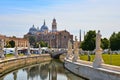 Prato della Valle square colorful buildings, church, architecture, water reflections on city canal and old facade with blue sky in Royalty Free Stock Photo