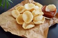 Prawn Crackers or Shrimp Chips with ketchup served on parchment paper, Fresh Krupuk on dark background