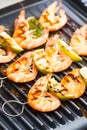 prawn skewers with lime on electric grill Royalty Free Stock Photo