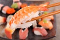 Prawn sushi held by chopsticks