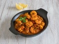 Prawns in curry sauce in a black pan close-up Royalty Free Stock Photo