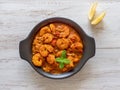 Prawns in curry sauce in a black pan close-up Royalty Free Stock Photo