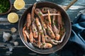 Prawns with lemon and herbs in metal pan