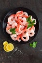 Prawns on plate. Shrimps, prawns. Seafood. Top view. Dark background