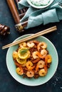 Prawns roasted on grill and boiled brown rice on plate. Grilled shrimps, prawns with rice. Seafood. Asian cuisine. Top view Royalty Free Stock Photo