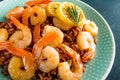 Prawns roasted on grill and boiled brown rice on plate. Grilled shrimps, prawns with rice. Seafood. Asian cuisine. Top view Royalty Free Stock Photo