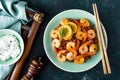 Prawns roasted on grill and boiled brown rice on plate. Grilled shrimps, prawns with rice. Seafood. Asian cuisine. Top view Royalty Free Stock Photo