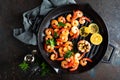 Prawns roasted on grill frying pan with lemon and garlic. Grilled shrimps, prawns. Seafood. Top view