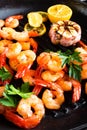 Prawns roasted on grill frying pan with lemon and garlic. Grilled shrimps, prawns. Seafood. Top view