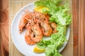 Prawns shrimps cooked burnt barbecue with lemon and vegetable salad - shrimp grilled bbq seafood on white plate table food Royalty Free Stock Photo