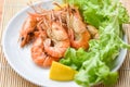 Prawns shrimps cooked burnt barbecue with lemon and vegetable salad - shrimp grilled bbq seafood on white plate table food Royalty Free Stock Photo