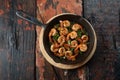 Prawns shrimps roasted on pan with herbs  on rustic wooden kitchen table Royalty Free Stock Photo