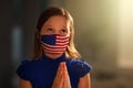 Pray for America. Child in face mask praying Royalty Free Stock Photo