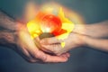 Pray For Australia. The hands of a man and a woman hold a globe. In the foreground, a map of Australia engulfed in fire. Close up Royalty Free Stock Photo