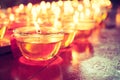 Pray candle glass on wood table in chinese temple Royalty Free Stock Photo