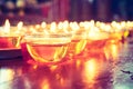 Pray candle glass on wood table in chinese temple