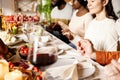 Happy family celebrate Thanksgiving day, sitting at table with roasted turkey and holiday traditional food, dishes. Royalty Free Stock Photo