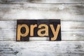 Pray Letterpress Word on Wooden Background Royalty Free Stock Photo