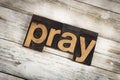 Pray Letterpress Word on Wooden Background Royalty Free Stock Photo