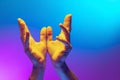 Pray for peace. Human hands gesturing on gradient blue and purple background in neon. Concept of human rights, social