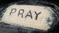 PRAY text written on white sand Royalty Free Stock Photo