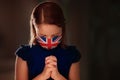 Pray for UK. Child in face mask praying Royalty Free Stock Photo