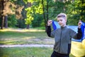 Pray for Ukraine. boy with Ukrainian flag running the summer park. Little kid waving national flag praying for peace. Happy child Royalty Free Stock Photo