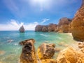 Praya de Marinha most beautiful beach in Algarve, Portugal. Cliffs on Coast of Atlantic ocean against blue sky