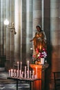 Prayer altar in a church with the virgin and lighted candles Royalty Free Stock Photo