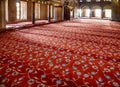 The prayer area covered with red carpets in Sultan Ahmed Mosque