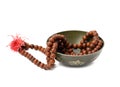 Prayer beads and copper singing bowl isolated on white background. Musical instrument for meditation, relaxation