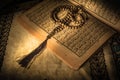 Prayer beads on Koran holy book of Muslims Royalty Free Stock Photo