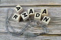 Prayer beads and wooden cubes with text RAMADAN Royalty Free Stock Photo