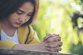 Prayer and bible concept.Asian female praying,hope for peace and free from coronavirus,Hand in hand together by woman, believes