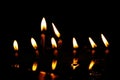 Prayer candles burning in silent darkness of temple, reflected in water Royalty Free Stock Photo