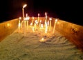 Prayer candles lighting in a church, Votive candles burns with an even flame in the Catholic Church. Royalty Free Stock Photo