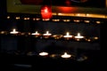 Prayer candles lit inside a church as a votive offering in an act or prayer Royalty Free Stock Photo