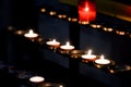 Prayer candles lit inside a church as a votive offering in an act or prayer Royalty Free Stock Photo