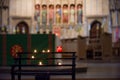 Prayer candles lit inside a church as a votive offering in an act or prayer Royalty Free Stock Photo