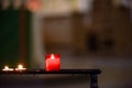 Prayer candles lit inside a church as a votive offering in an act or prayer Royalty Free Stock Photo