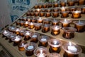 Prayer candles in votives, and insence, inside of a Catholic church