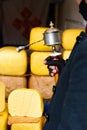 Prayer drum in mans hand in front of yak butter in shop of the Lhasa street in Tibet